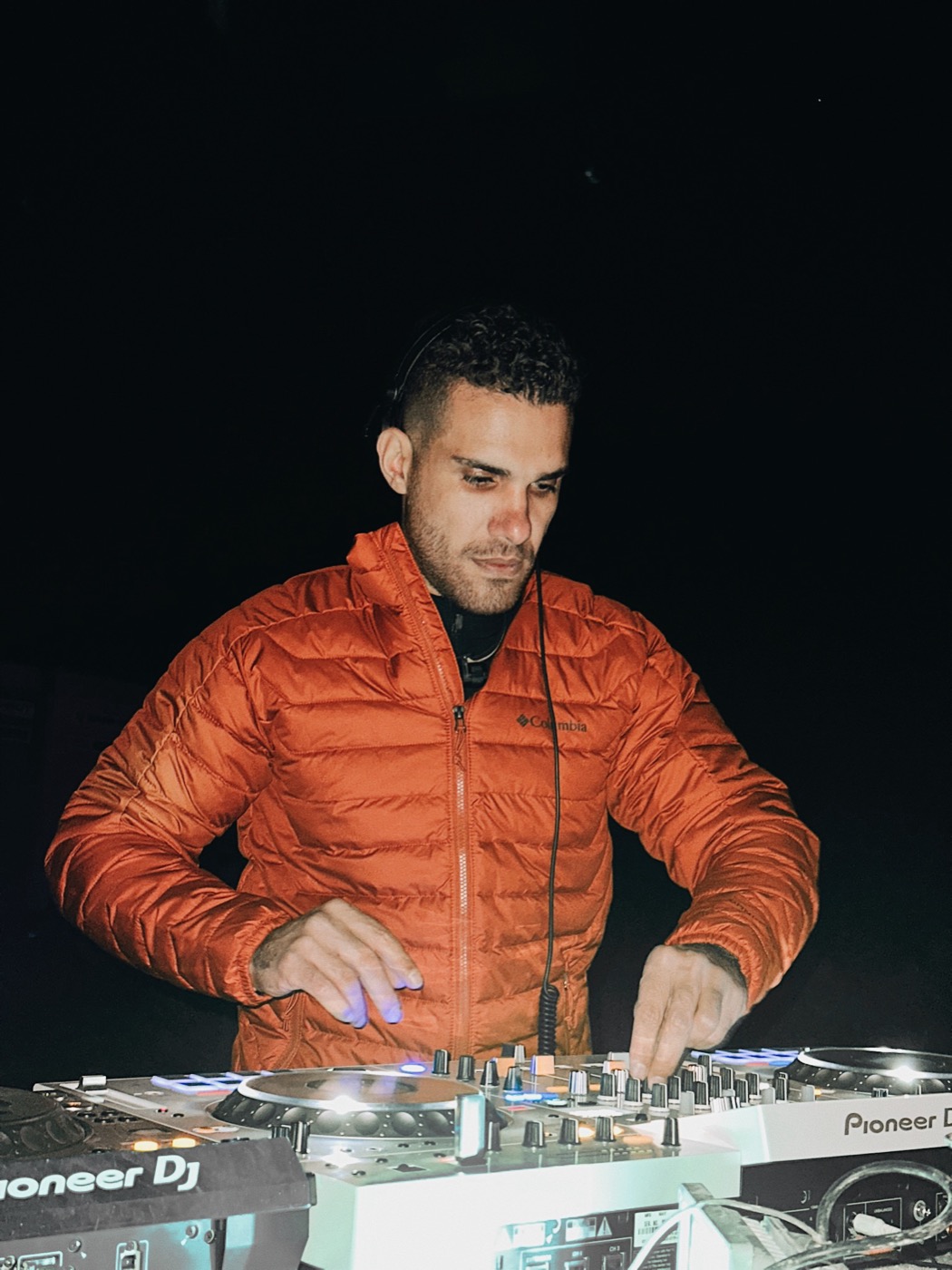 Hayden DJing on Pioneer decks at night